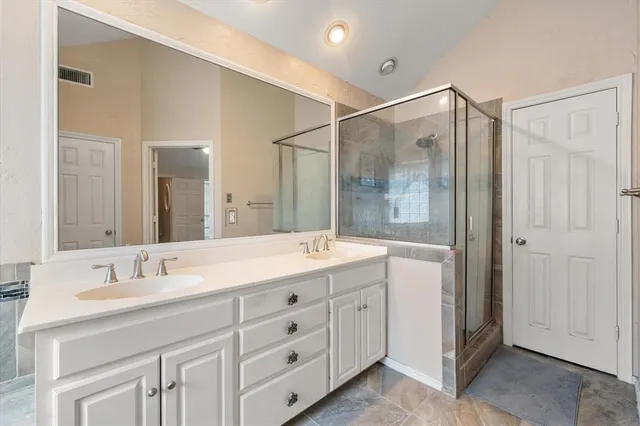 a bathroom with a granite countertop sink mirror and double