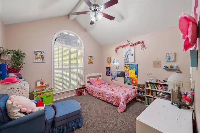 a bedroom with two beds and a window