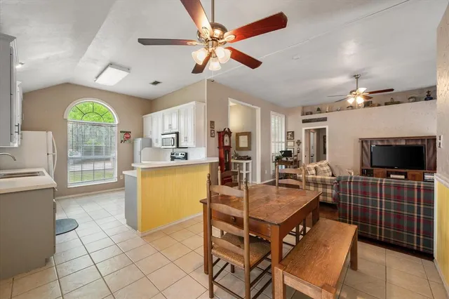 a dining room with furniture and a flat screen tv