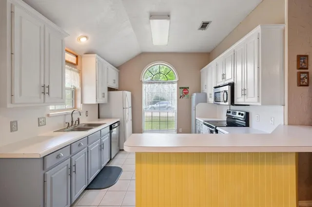 a large bathroom with a large window and double vanity