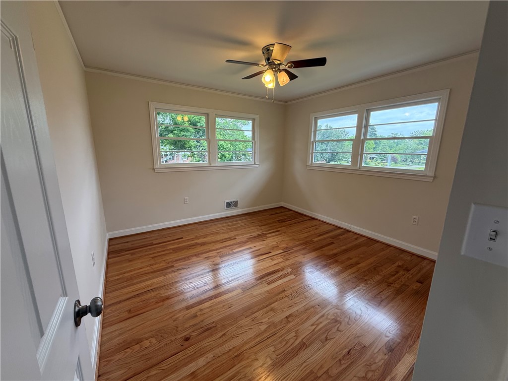 2304 Poplar Lane Anderson, SC 29621 - Photo 25 of 33 This airy room features rich hardwood flooring and large windows, perfect for relaxation.