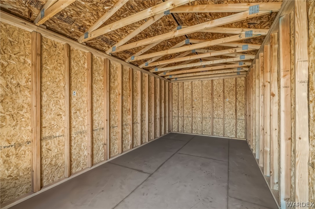 4088 Mercer Road Bullhead City, AZ 86429 - Photo 23 of 35 Unfinished interior space featuring exposed wood studs, oriented strand board paneling, and a concrete floor
