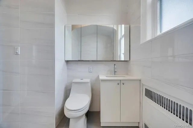 a spacious bedroom with a bed and a chandelier