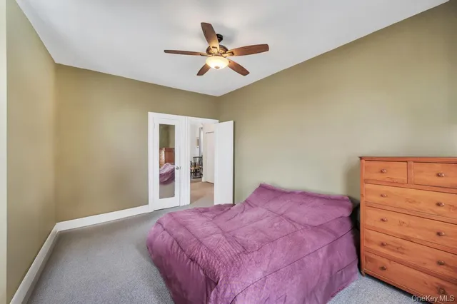a view of a bedroom with furniture and a window