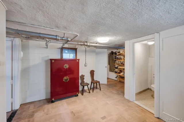 a view of a storage & utility room with refrigerator