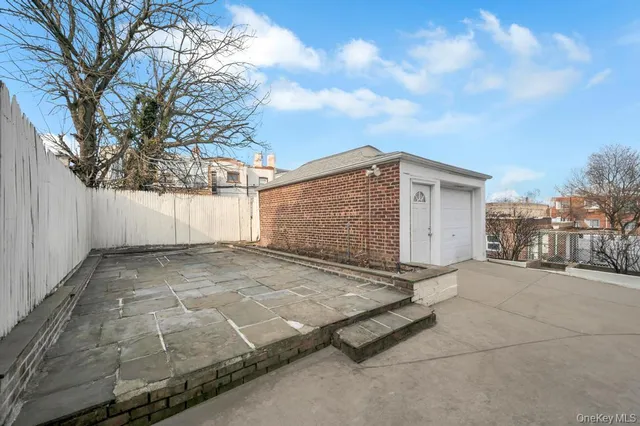 a view of a grey house with a garage