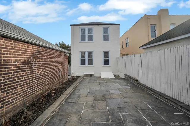 a front view of a multi story residential apartment building with a yard