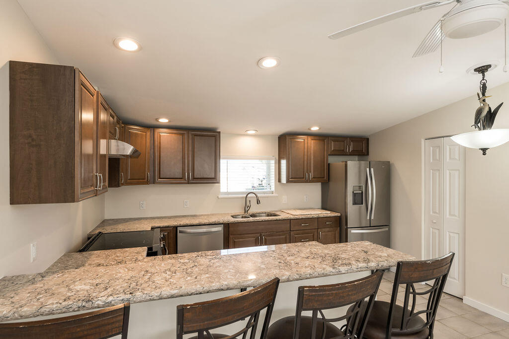 17279 Pine Tree Lane Sugarloaf, FL 33042 - Photo 17 of 33 a kitchen with granite countertop kitchen island stainless steel appliances a sink and a refrigerator