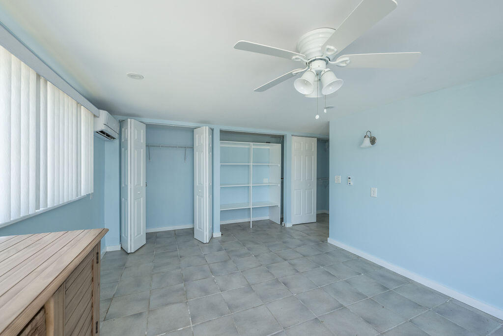 17279 Pine Tree Lane Sugarloaf, FL 33042 - Photo 22 of 33 a view of an empty room with a ceiling fan and entryway