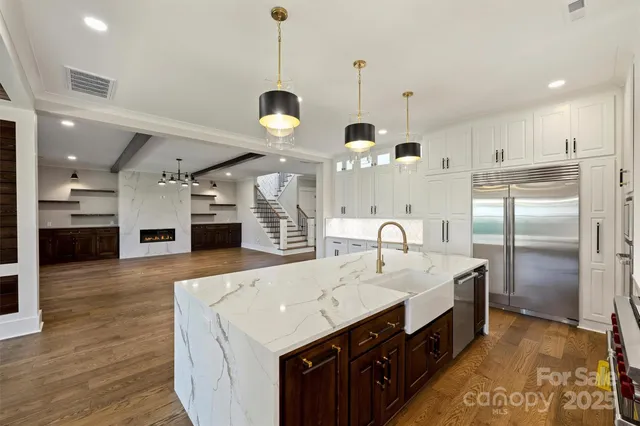 a bathroom with a granite countertop shower and a sink