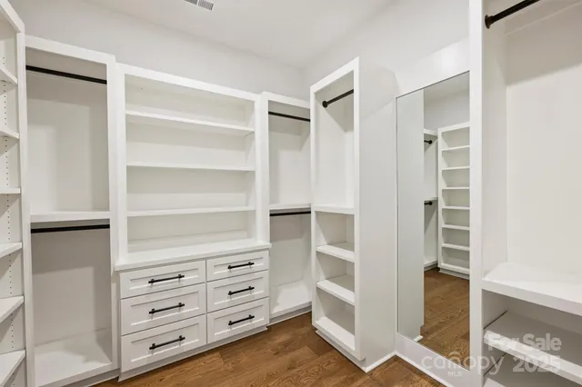 a bathroom with a granite countertop sink toilet a large mirror a shower and vanity