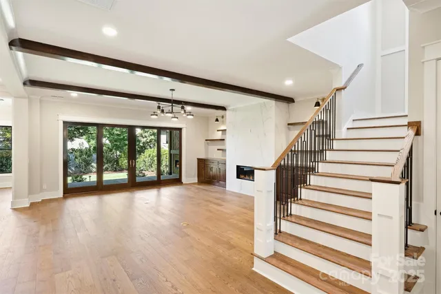 a large kitchen with stainless steel appliances granite countertop a stove and a wooden floors