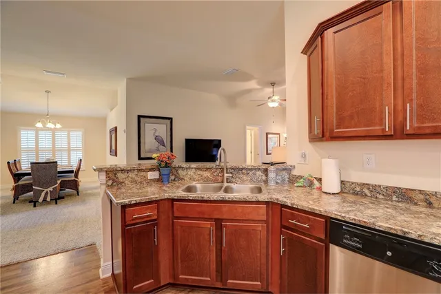 a kitchen with stainless steel appliances granite countertop a sink stove and cabinets
