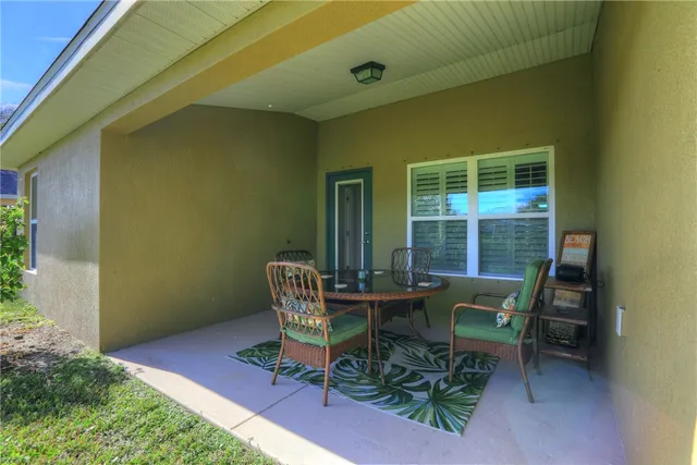 a wooden bench sitting in front of a building