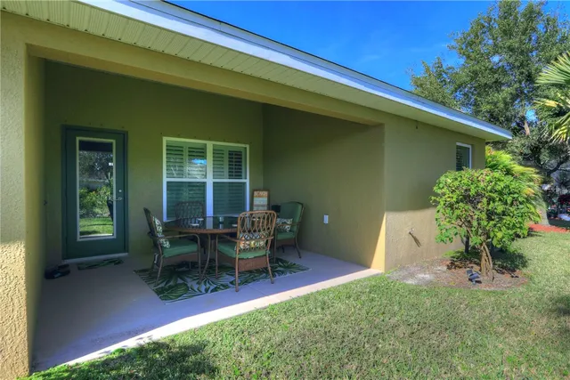 a view of a house with backyard sitting area and garden