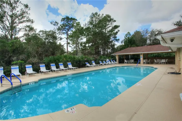 a view of swimming pool with chairs