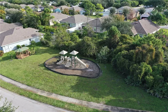 an aerial view of a house with a yard