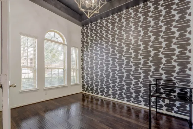 a view of a livingroom with wooden floor and a window