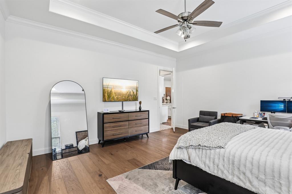 515 West Laureland Road Dallas, TX 75232 - Photo 21 of 32 a bedroom with a bed and a chandelier