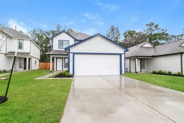 a front view of a house with a yard and garage