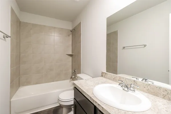 a bathroom with a sink a toilet and a mirror