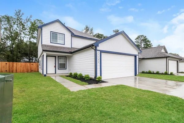 a front view of a house with a garden and plants