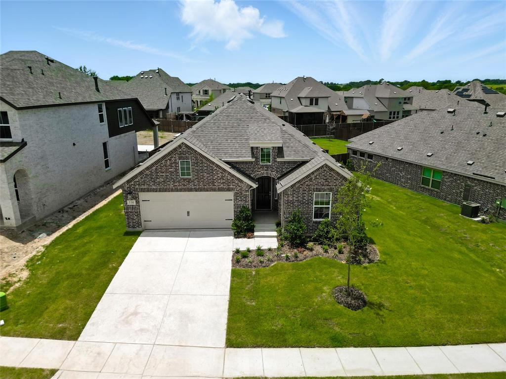 530 Red Barn Drive Van Alstyne, TX 75495 - Photo 29 of 40 French country home featuring a residential view, brick siding, driveway, and roof with shingles