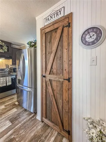 a view of a kitchen with wooden floor and a kitchen