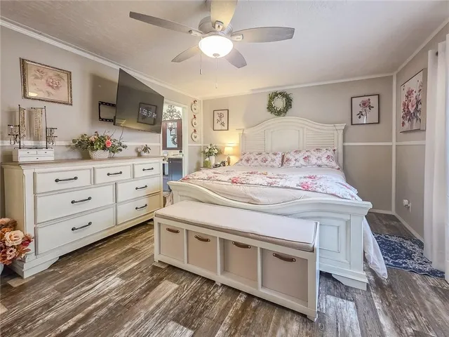 a spacious bedroom with a bed and a dresser in it