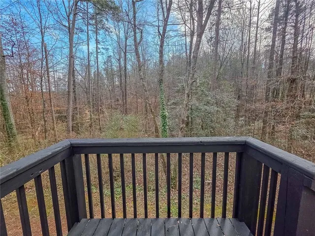 a view of a balcony with wooden fence and floor