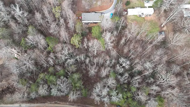 an aerial view of a house with outdoor space and a lake view