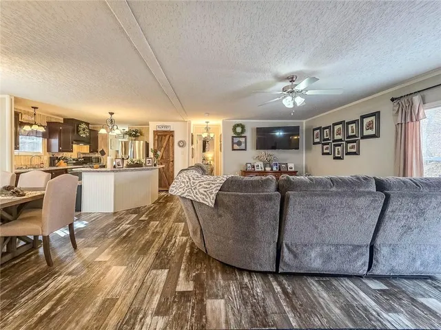 a living room with furniture and kitchen view