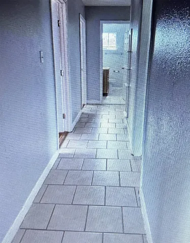 a bathroom with a glass door shower and a sink