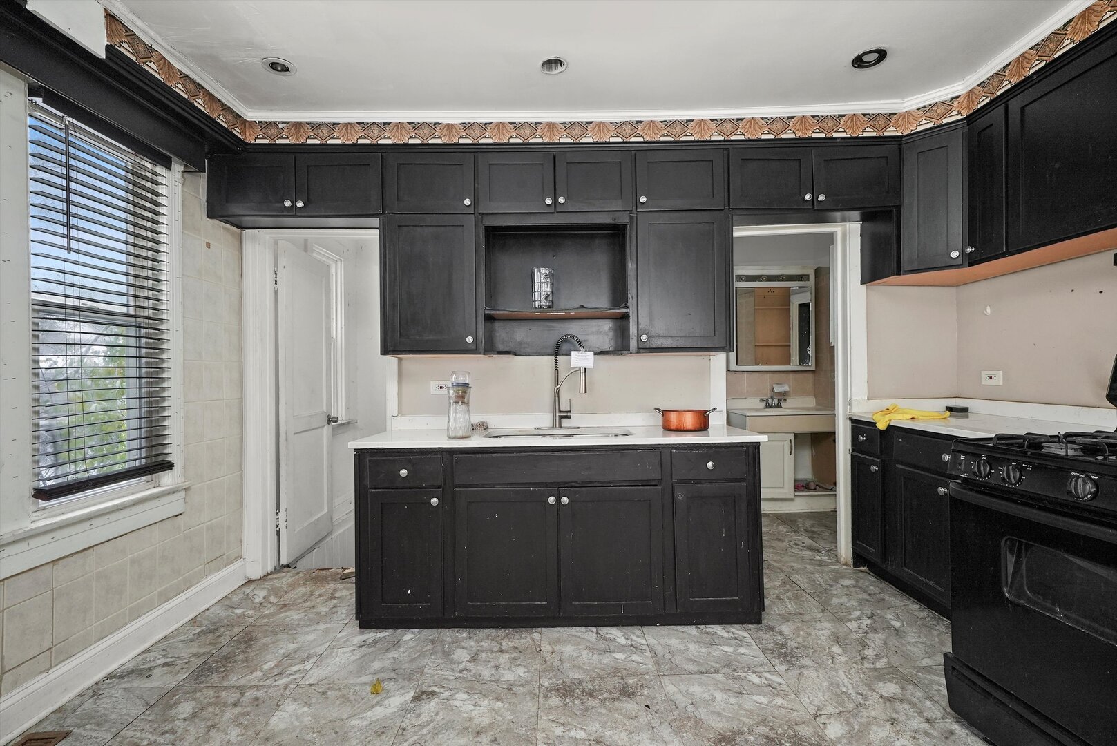 10446 South State Street Chicago, IL 60628 - Photo 12 of 25 a kitchen with stainless steel appliances granite countertop a sink and a stove