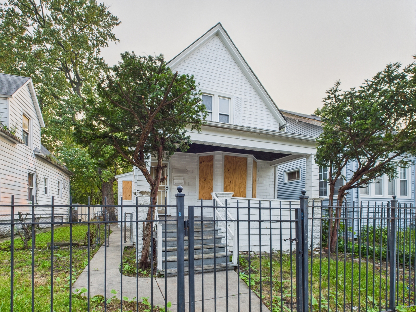 10446 South State Street Chicago, IL 60628 - Photo 2 of 25 a front view of a house with a porch