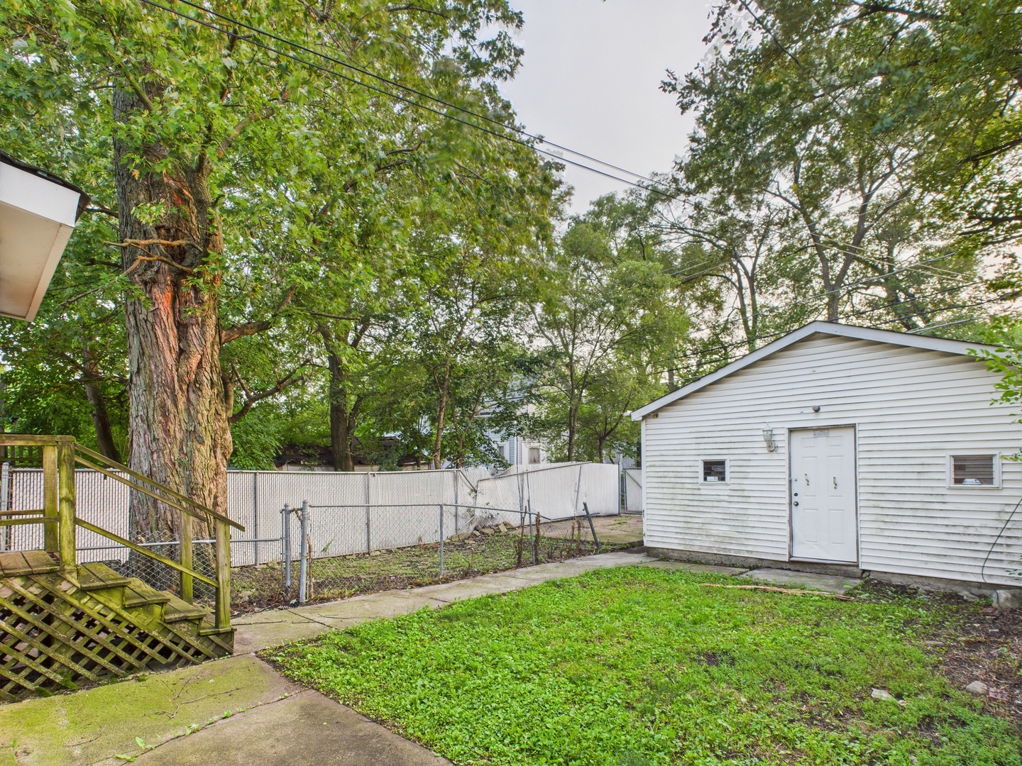10446 South State Street Chicago, IL 60628 - Photo 23 of 25 a view of an house with backyard space and tree