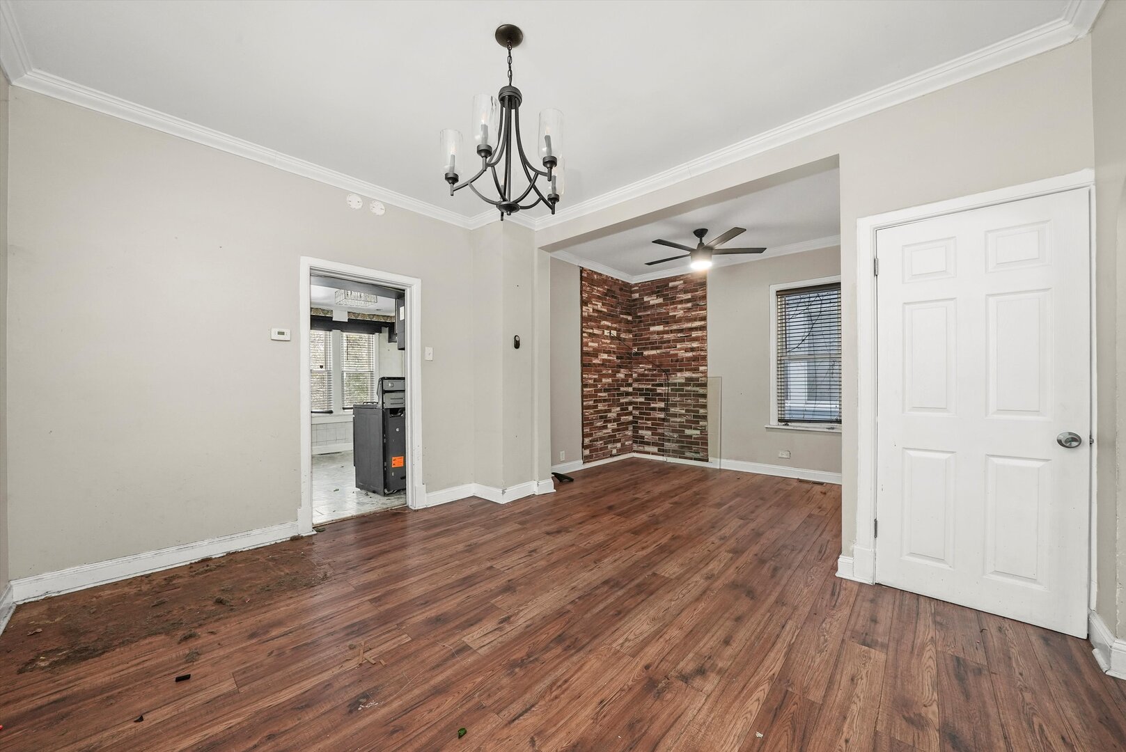 10446 South State Street Chicago, IL 60628 - Photo 5 of 25 a view of a livingroom with a chandelier fan and wooden floor