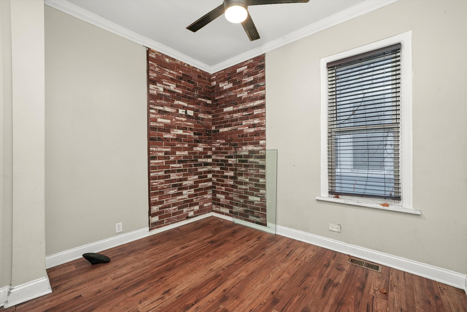 10446 South State Street Chicago, IL 60628 - Photo 7 of 25 a view of an empty room with a window and wooden floor