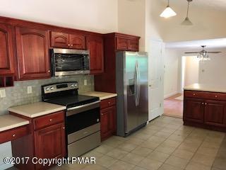 197 Devils Hole Road Cresco, PA 18326 - Photo 15 of 27 a kitchen with stainless steel appliances granite countertop a stove a refrigerator and a sink
