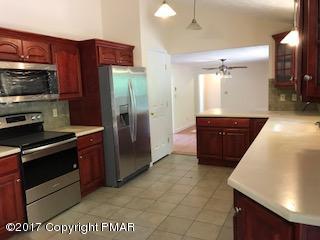 197 Devils Hole Road Cresco, PA 18326 - Photo 20 of 27 a kitchen with stainless steel appliances granite countertop a refrigerator and a sink