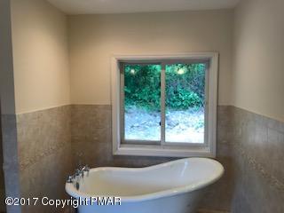 197 Devils Hole Road Cresco, PA 18326 - Photo 21 of 27 a bath tub sitting in a bathroom next to a window
