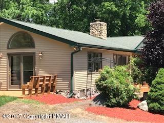 197 Devils Hole Road Cresco, PA 18326 - Photo 24 of 27 a view of a chairs and table in the back yard of the house