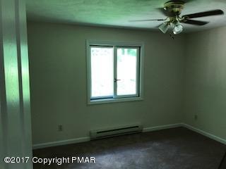 197 Devils Hole Road Cresco, PA 18326 - Photo 4 of 27 an empty room with a window and a fan