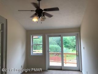 197 Devils Hole Road Cresco, PA 18326 - Photo 7 of 27 a view of a livingroom with a ceiling fan and window