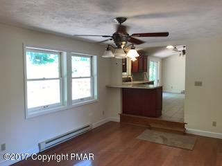 197 Devils Hole Road Cresco, PA 18326 - Photo 8 of 27 a view of a room with a ceiling fan window and a chandelier