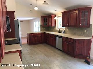 197 Devils Hole Road Cresco, PA 18326 - Photo 10 of 27 a kitchen with stainless steel appliances granite countertop wooden cabinets a sink and dishwasher