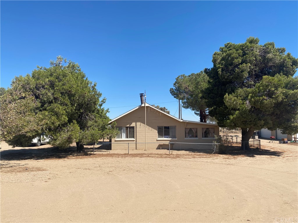 9725 Caughlin Road Phelan, CA 92371 - Photo 1 of 1 a view of house with a yard and covered with snow in the background