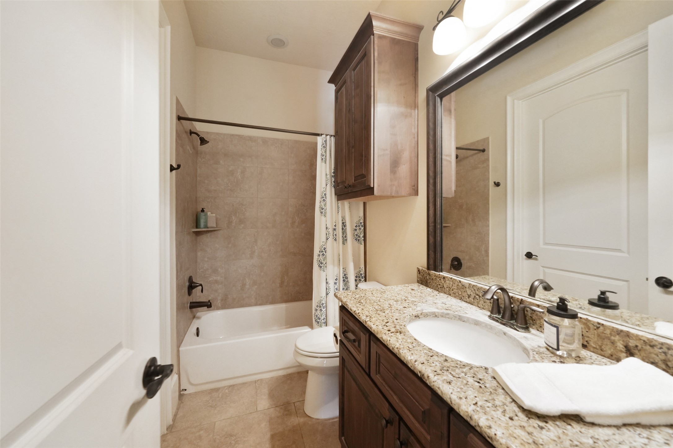 26250 A Riley Road Waller, TX 77484 - Photo 21 of 50 Wing bath with granite vanity, framed mirror, and tiled tub/shower serving game room and study.