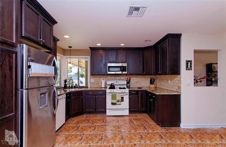 888 Appleton Road Simi Valley, CA 93065 - Photo 2 of 30 a kitchen with stainless steel appliances granite countertop a stove top oven a sink dishwasher a refrigerator and a cabinets with wooden floor