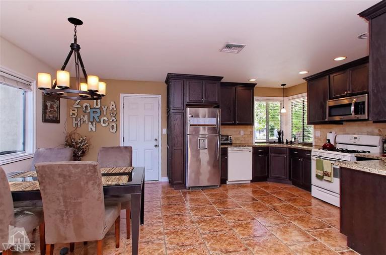 888 Appleton Road Simi Valley, CA 93065 - Photo 22 of 30 a kitchen with refrigerator a stove a sink and chairs